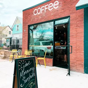 a sign in front of a coffee shop