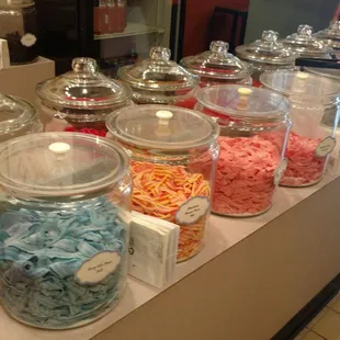 a variety of candy in glass jars