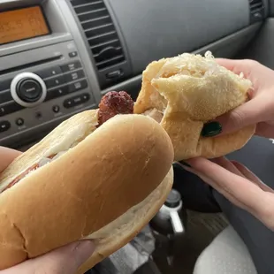 two hands holding a hot dog