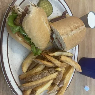 Grilled chicken and bacon sandwich with crispy fries