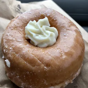 a glazed doughnut with whipped cream