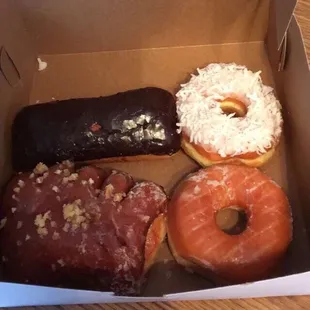 Bear claw, glazed, coconut, and chocolate covered cream filled