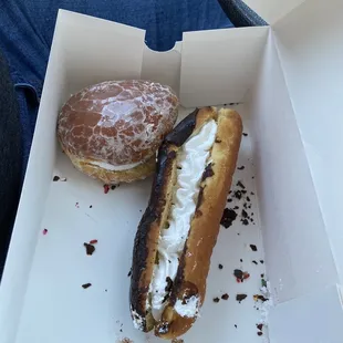 a half eaten doughnut and a half eaten donut