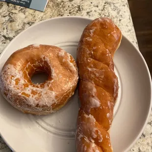 two glazed donuts on a plate