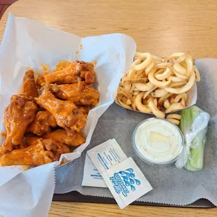 a tray of wings and fries