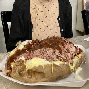 Loaded potato to the extreme. I used my mother in law for scale. She was not harmed in the taking of this picture.