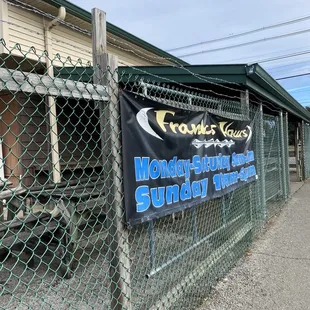 a banner on a chain link fence