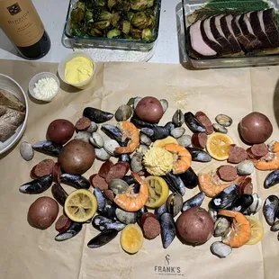 Seafood boil, bread, brussel sprouts, pork loin, Caesar salad. Wine not included.