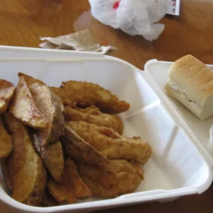 a tray of fried potatoes and a roll
