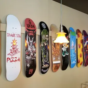 a wall of skateboards