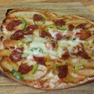 a pepperoni pizza on a wooden cutting board