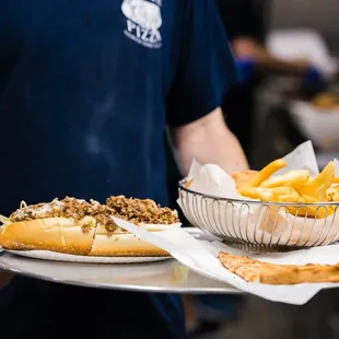 a man holding a tray of food