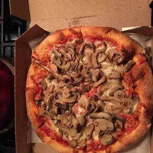 Small mushroom pizza with extra mushrooms .