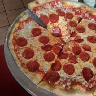 a pepperoni pizza on a pan