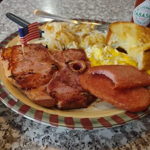 Frank&apos;s breakfast So delicious huge tender pork chop some fried spam hash browns and a tasty piece of bread