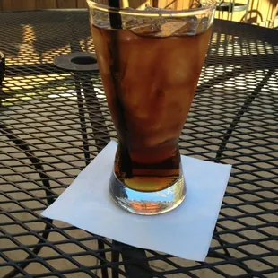 The beloved cap&apos;n and diet on the patio.