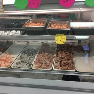 a variety of seafood in a display case