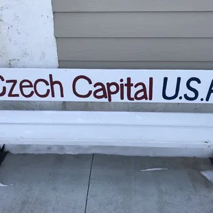 a bench with a sign that reads gech capital usa