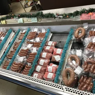 a display of sausages and pretzels