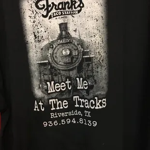 a black t - shirt with a train on it