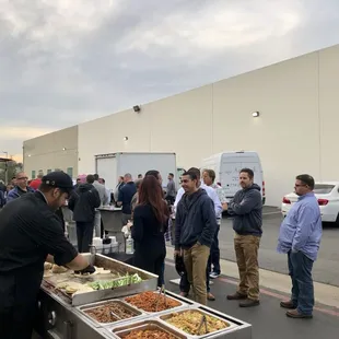 a large group of people standing in a parking lot