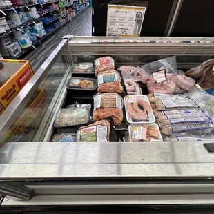 a variety of meats in a display case