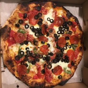 Pizza margherita with pepperoni and olives