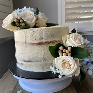 Semi naked cake with fresh flowers for a birthday celebration.