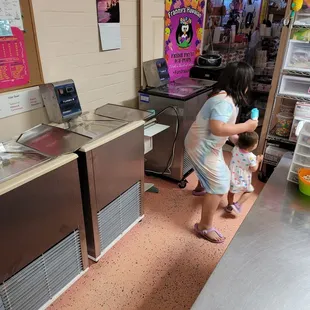 a little girl standing in front of the counter