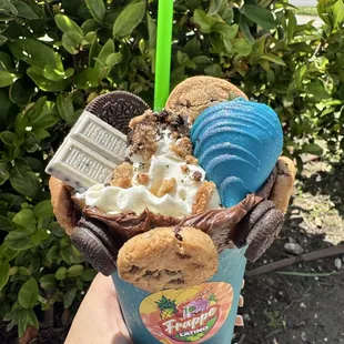 Cookie Monster frappe (milkshake) this drink that is being shown is a drink where its crafted with different varieties of cookies