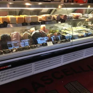 a deli case filled with different types of cheese