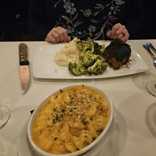 Pork chop, broccoli and mashed potatoes and mac and cheese.