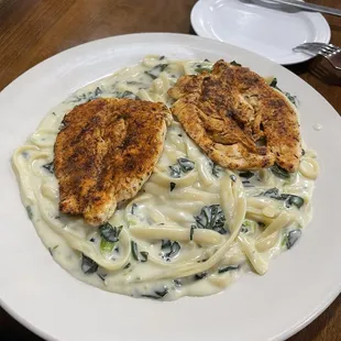 Blackened chicken fettuccine Alfredo with spinach and garlic