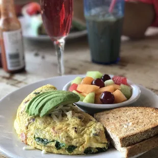 Bon appetite  Omelette with toast, fruit and a lovely mimosa