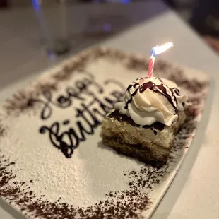 a piece of cake with a lit candle