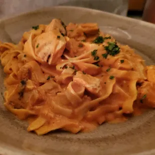 Fettuccine with chicken and pink sauce.