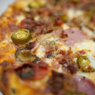 Build your own with red sauce, bacon, pepperoni, sausage, mushrooms, and jalapeños. Yum! @coreyd123 on insta