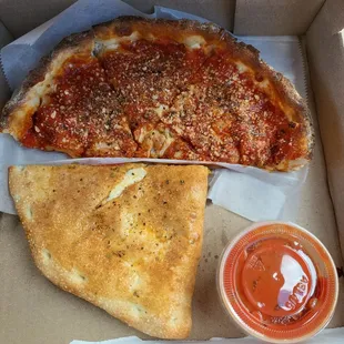 Half a Calzone and half deep dish pizza