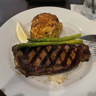 Steak and crab cake with asparagus.