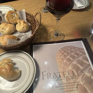 Yummy complimentary garlic rolls and a glass of Pinot noir.
