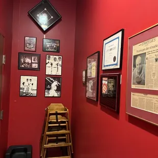 a red wall with a wooden ladder