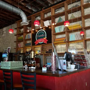 a bar with red chairs