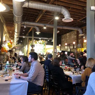 a large group of people sitting at tables