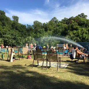 a group of people sitting around a fire pit