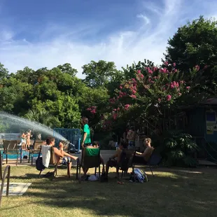 a group of people sitting around a pool