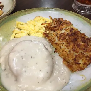 Biscuits and gravy with hash browns and eggs