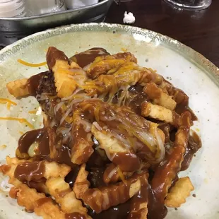 Open faced burger with brown gravy and cheesy fries