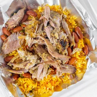 Our delicious pernil meal served over mouth watering Spanish rice and beans.