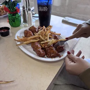 Bone-out sweet honey chili sauce with a side of fries