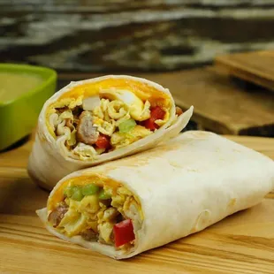 two burritos on a cutting board